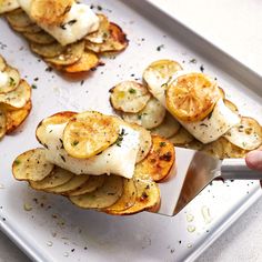 someone is cutting up some food on a tray