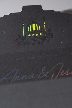 the back side of a black card with an image of a building on it