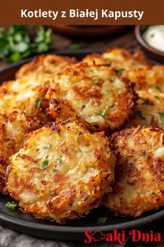 some crab cakes are on a black plate