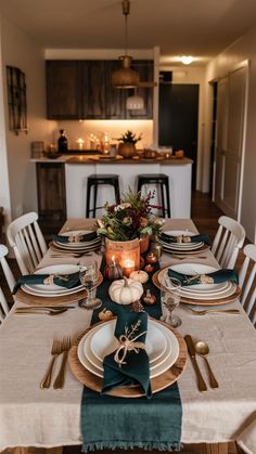 a dining room table set with place settings