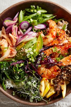 a bowl filled with shrimp and vegetables on top of a table