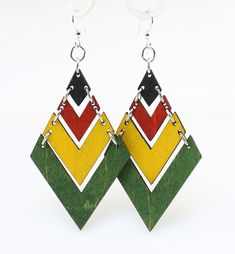 the earrings are made out of wood and have multicolored geometric designs on them