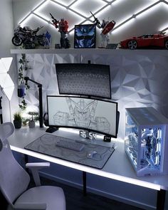 a desk with a computer and some cars on it