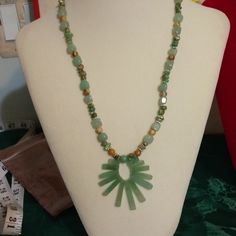 Green Aventurine Is The Main Focal Point Of The Sunburst. Necklace Made Up Of Green Aventurine Beads, Light Brown Picture Jasper Beads, Natural Green Turquoise Chips And Silver Plated Rounds. A Large Lobster Claw Clasp Secured This Necklace. Length 20 Inches, Focal Is Additional 2 Inches . Bohemian Green Aventurine Necklaces, Bohemian Green Aventurine Necklace, Handmade Green Turquoise (amazonite) Necklace, Handmade Green Turquoise Necklace In Amazonite, Green Amazonite Gemstone Turquoise Necklace, Green Aventurine Beaded Necklace Bohemian Style, Green Amazonite Gemstone Beaded Necklace, Green Amazonite Bohemian Beaded Necklace, Green Amazonite Bohemian Necklace