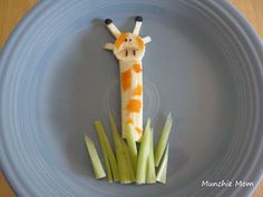 a giraffe made out of celery on a plate