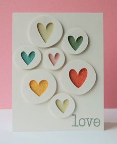 a card that has hearts on it with the word love written in front of them