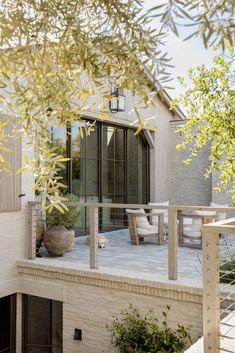 an outdoor patio with chairs and tables on it