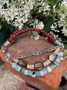 "Is it time for some new bling?  Yep, I thought so! Three-strand beaded and hand-braided leather cord (braided with four strands of leather cording) boho-style bracelet with a definite southwestern flair features both new and vintage jewelry findings for this one-of a kind piece.  Light blue beads with a slight sparkle play beautifully off of the silver floral links, while the tan seed beeds and large brown beads give this a western edge and make this a true cowgirl statement piece that is able Beaded Turquoise Crystal Bracelet As Gift, Adjustable Handmade Bracelets, Handmade Adjustable Bracelet For Accessorizing, Turquoise Beaded Charm Bracelet For Gift, Turquoise Beaded Wrap Bangle Bracelet, Turquoise Beaded Charm Bracelet Gift, Adjustable Double Strand Bracelet With Lobster Clasp, Handmade Bohemian Bracelets For Accessorizing, Adjustable Turquoise Jewelry With Lobster Clasp