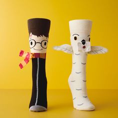 two sock dolls made to look like harry potter and hermiels are standing next to each other