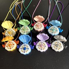 six different colored necklaces with flowers on them