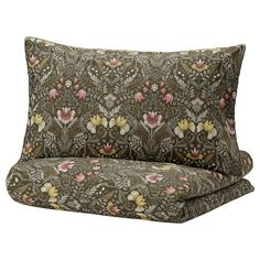 a brown and pink floral print pillow with two matching pillows on the bottom one side