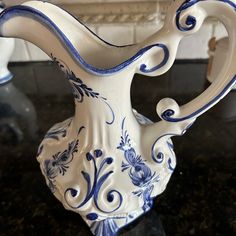 a blue and white vase sitting on top of a table