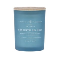 a blue glass candle that says hyacinth sea salt on the front and side