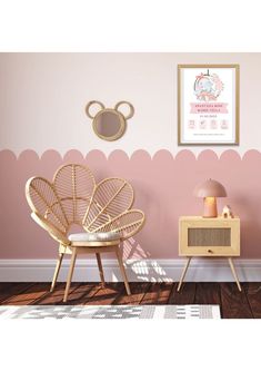 there is a rattan chair next to a table and lamp in the room with pink walls