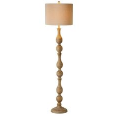 a wooden floor lamp with a white shade on it's base and a beige linen shade