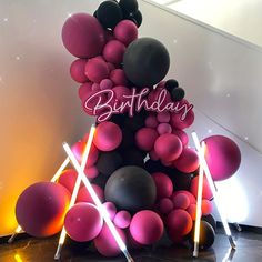 a birthday cake made out of balloons and sticks