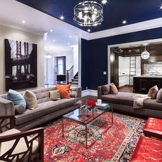 a living room filled with furniture and a fire place in the middle of a room