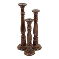 three wooden candlesticks sitting next to each other