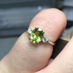 A simple silver setting with a 8x6mm Peridot and 2 2.75mm CZ accents. (prices subject to change depending on stone, metal, and size) ⇢Metal Available: ✦ Silver ✦ 14kt Gold Oval Peridot Solitaire Jewelry, Oval Peridot Rings Fine Jewelry, Oval Peridot Rings With Accent Stones, Lime Green Oval Rings Fine Jewelry, Lime Green Oval Rings With Accent Stones, Oval Lime Green Fine Jewelry Ring, Lime Green Oval Fine Jewelry Rings, Oval Peridot Birthstone Ring In Fine Jewelry, Oval Peridot Gemstone Ring