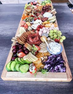 a long wooden tray filled with different types of food