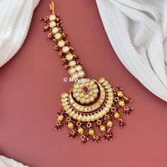 Premium quality oversized kundan mangtika in beautiful ruby red color with heavy pearl details. Inspire your style with this premium quality large mangtika on your wedding day.  All orders Ship same day if placed before 4:00 PM EST  Mangtika Length: 5.4 inch Mangtika Width: 2.5 inch Create beautiful memory for any occasion with elegant jewelry for your loved ones We will be happy to navigate you through the process so if you have any questions regarding our product before placing an order reach Kundan Temple Jewelry Tikka For Rituals, Red Temple Jewelry Tikka For Wedding, Kundan Chandbalis With Pallu For Rituals, Red Chandbali Tikka For Wedding, Heavy Wedding Tikka For Navratri, Kundan Temple Jewelry Tikka For Wedding, Kundan Tikka For Wedding, Temple Jewelry Style, Kundan Hand-set Tikka For Puja, Red Kundan Tikka For Wedding