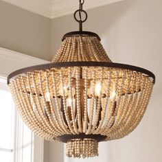 a chandelier made out of beads hanging from a ceiling fixture in a room