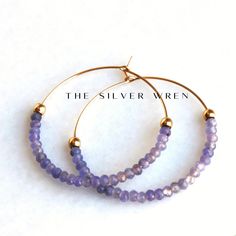 Tanzanite Gold Hoop Earrings D E T A I L S These gorgeous hoop earrings are created with Genuine Natural Tanzanite 3mm beads and 14kt gold filled accents   Beaded by hand  14kt gold filled 35mm hoops  ∙ EXTRA LOVE ∙ Crafted and curated just for you in the desert of our Arizona studio. All of our jewelry comes gift packaged!  We are happy to leave a note if this is a special gift, just let us know in the message box at checkout.  PRODUCTION ∙ TIMES All items are made to order. Please check the to Faceted Hoop Earrings As Gift, Faceted Hoop Jewelry For Gifts, Jewelry Hoop Earrings, Earrings Gold Hoop, Tanzanite Jewelry, Tanzanite Earrings, Gift Best Friend, Hoop Earrings Gold, Natural Tanzanite