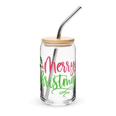 a glass jar with a straw in it and merry christmas lettering on the lid is shown