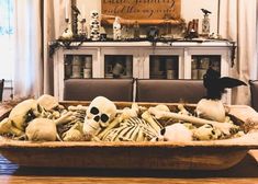 a large wooden bowl filled with fake skeletons