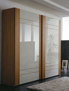 a modern bedroom with white and wood furniture in the room, along with a large rug on the floor