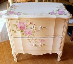 an old dresser with flowers painted on it