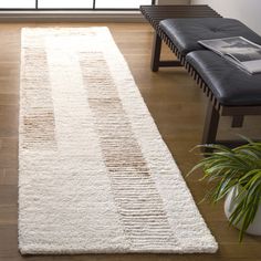 a large white rug in the middle of a living room