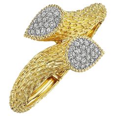 Slither and slide 24/7 with this iconic Boucheron Paris vintage Serpent Boheme diamond gold hinged platinum and 18 karat yellow gold cuff bracelet. With two diamond heads and hand engraved serpent body scales, this stylized snake bracelet is filled with timeless power. Circa 1975. Total diamond weight 2.65 carats. Size small to medium. Hinged back opening. Yellow Gold Diamond Bracelet For Evening, Evening Gold Diamond Bracelet, Gold Diamond Evening Bracelet, Formal Gold Cuff Bracelet With Pave Setting, Formal Gold Diamond Cuff Bracelet, Gold Pave Setting Cuff Bracelet For Formal Occasions, Formal Yellow Gold Diamond Cuff Bracelet, Gold Diamond Bracelet With Accents For Evening, Yellow Gold Cuff Bracelet