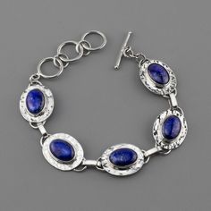 Getting compliments on your accessories makes any day instantly better, so expect to have the time of your life whenever you are wearing this lapis bracelet. Boasting oval blue gemstones set in a hammered silver setting, this stunner will bring a summer vibe to the gloomiest days. Gemstone - Genuine Lapis Lazuli 950 Sterling silver Textured finish Adjustable from 7 to 8.5" L Handmade in Taxco, Mexico Lapis Bracelet, Lapis Lazuli Bracelet, Silver Link Bracelet, Time Of Your Life, Lapis Lazuli Stone, Hammered Silver, Blue Gemstones, Blue Bracelet, Lapis Lazuli