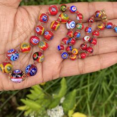 Vintage ~ handmade ~ Italian Millefiori glass beaded necklace ~ All beads are hand knotted with barrel clasp at the end ~ Colorful glass beads . Dates mid to late 20th century ~ Unsigned Materials : Glass beads gold tone metal Measurements : Necklace is 16 1/2 inches in length x 1/2 inches max width . Smallest Bead is 1/4 inches in diameter and largest is 1/2 inches in diameter . Condition : Good vintage condition ~ No major cracks or chips to any of the glass beads ~ Clasp is in good working or Murano Glass Necklaces, Necklace Dress, Turquoise Bead Necklaces, Onyx Bead, Sterling Silver Hoop Earrings, Glass Bead Necklace, Drop Pendant, Glass Necklace, Vintage Costume Jewelry