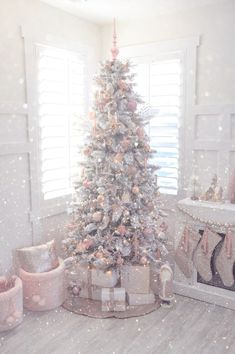 a white christmas tree in front of a window with the words happy wednesday on it