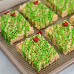 rice krispy treats are decorated with green sprinkles and red heart shapes