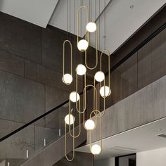 a modern chandelier hangs from the ceiling above a dining room table