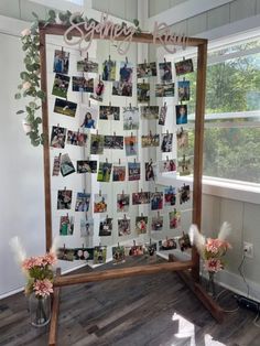 a wooden frame with pictures and flowers on it