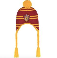 a harry potter knitted hat with pom - pom on the front and side