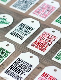 christmas gift tags on a table with the words merry and happy written in red, green, and white