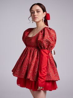 Red brocade dress with large sleeves, narrow cuffs and open neckline. The puffy skirt consists of three layers. The back closure imitates corset lacing and is tied with a bow. Limited edition Red brocade embroidered with a floral pattern Fabric: 70% viscose, 30% polyester The model is wearing size S Made in Czech Republic Festive Embroidered Brocade Dress, Red Brocade Set With Intricate Embroidery, Luxury Red Brocade Dresses, Embroidered Red Brocade Set, Red Rococo Dress, Megan Dress, Floral Pattern Fabric, Corset Lacing, Puffy Skirt