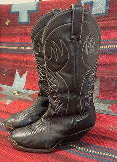 "From Blackbird Vintage of Sedona, Arizona  This is a great pair of authentic Vintage Men's Black Cowboy boots, size 8 D. (Most likely would also fit a ladies 9.5) 12\" tall.  They feature silver metal tips, a very unique heel and are made in Mexico, circa 1950s. measurements: Height: 14 inches, inclusive of 2 3/8 inch heel Heel to toe: 10.5 inches width, widest part of sole: 3 7/8 inches circumference around top of calf: 15\" They are quite distressed and very worn in, with many scuffs and nick Fitted Vintage Boots With Goodyear Welted, Fitted Vintage Boots With Goodyear Welt, Vintage Goodyear Welted Boots For Fall, Vintage Black Winter Boots, Vintage Formal Boots For Winter, Fitted Vintage Black Boots, Vintage Pointed Toe Boots For Rodeo, Vintage Western Boots With Pointed Toe, Vintage Brown Boots For Western-themed Events