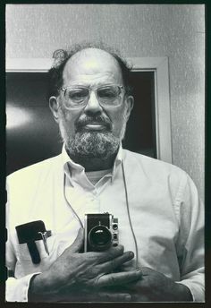 an old man holding a camera in his hands