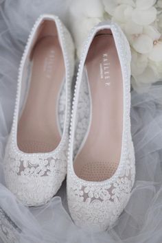 wedding shoes with white lace and flowers in the background