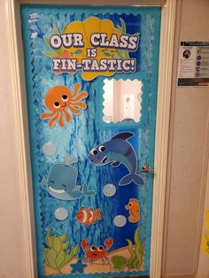 a door decorated with an ocean theme and under the sea stickers on it's side