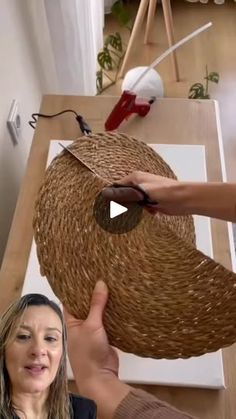 a woman is making a basket out of wicker with scissors and glue on it