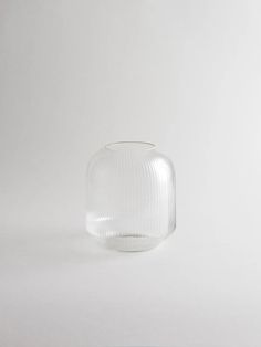 a glass vase sitting on top of a white table