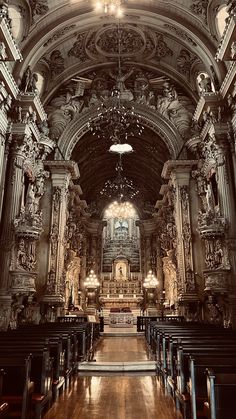 the interior of an old church with pews