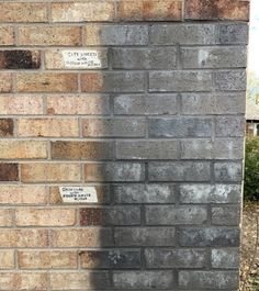 a brick wall with some writing on it